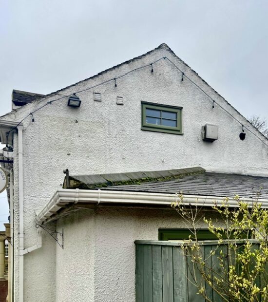 Stained render before softwash cleaning